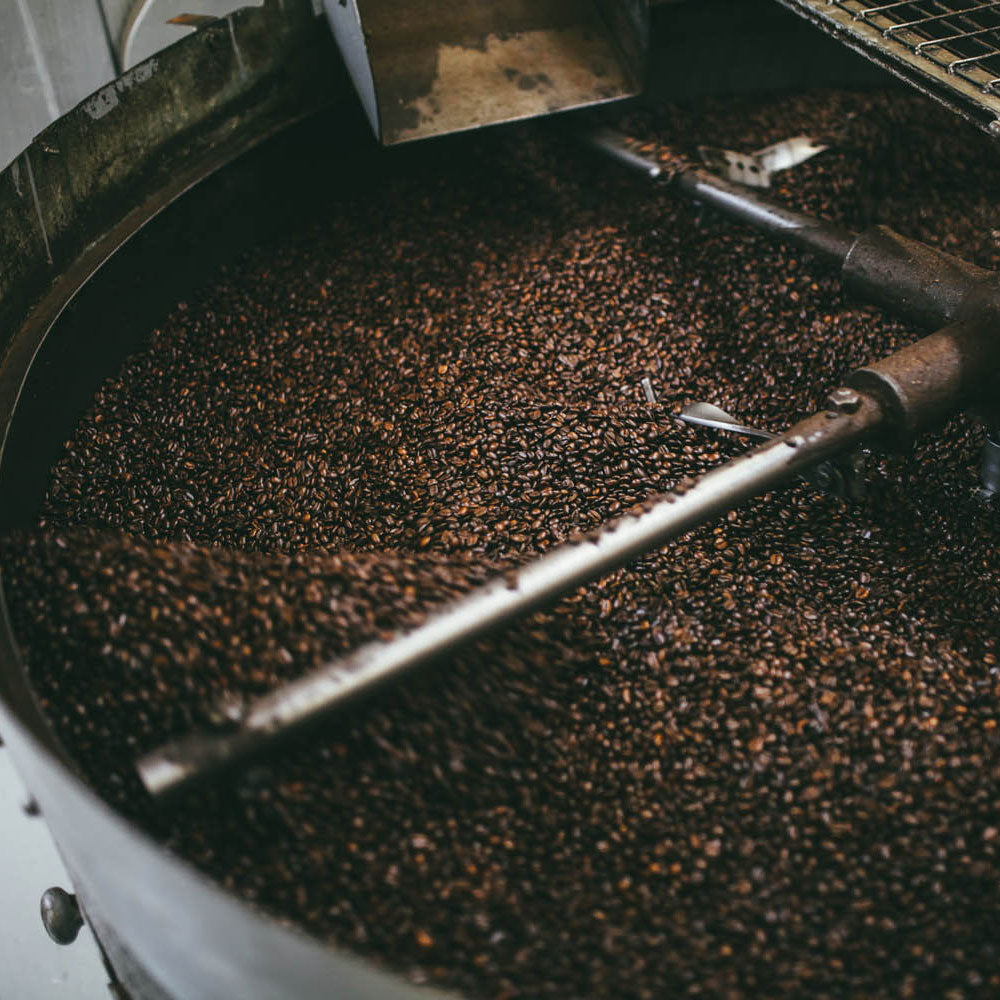 roasted coffee in the cooling tray waiting to be process for grinding