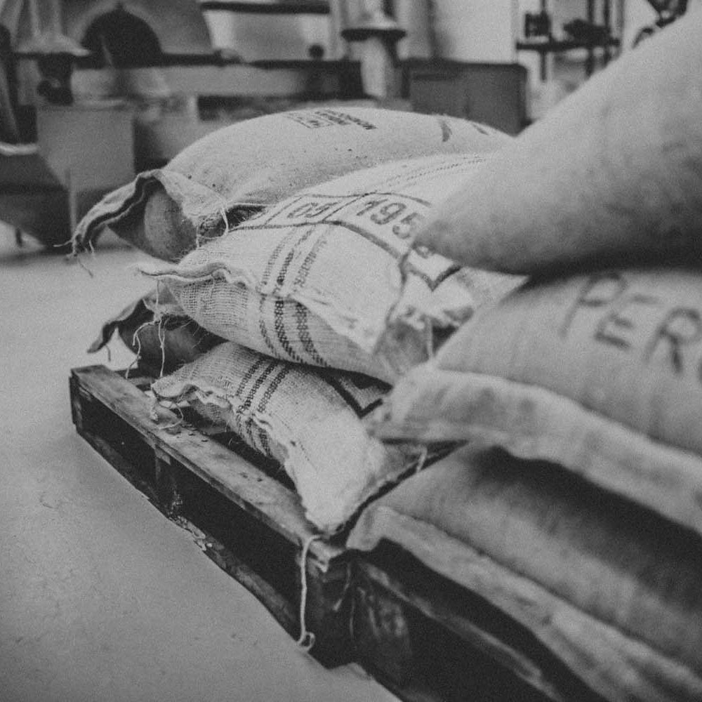 lovely black and white image of the raw coffee sacks 