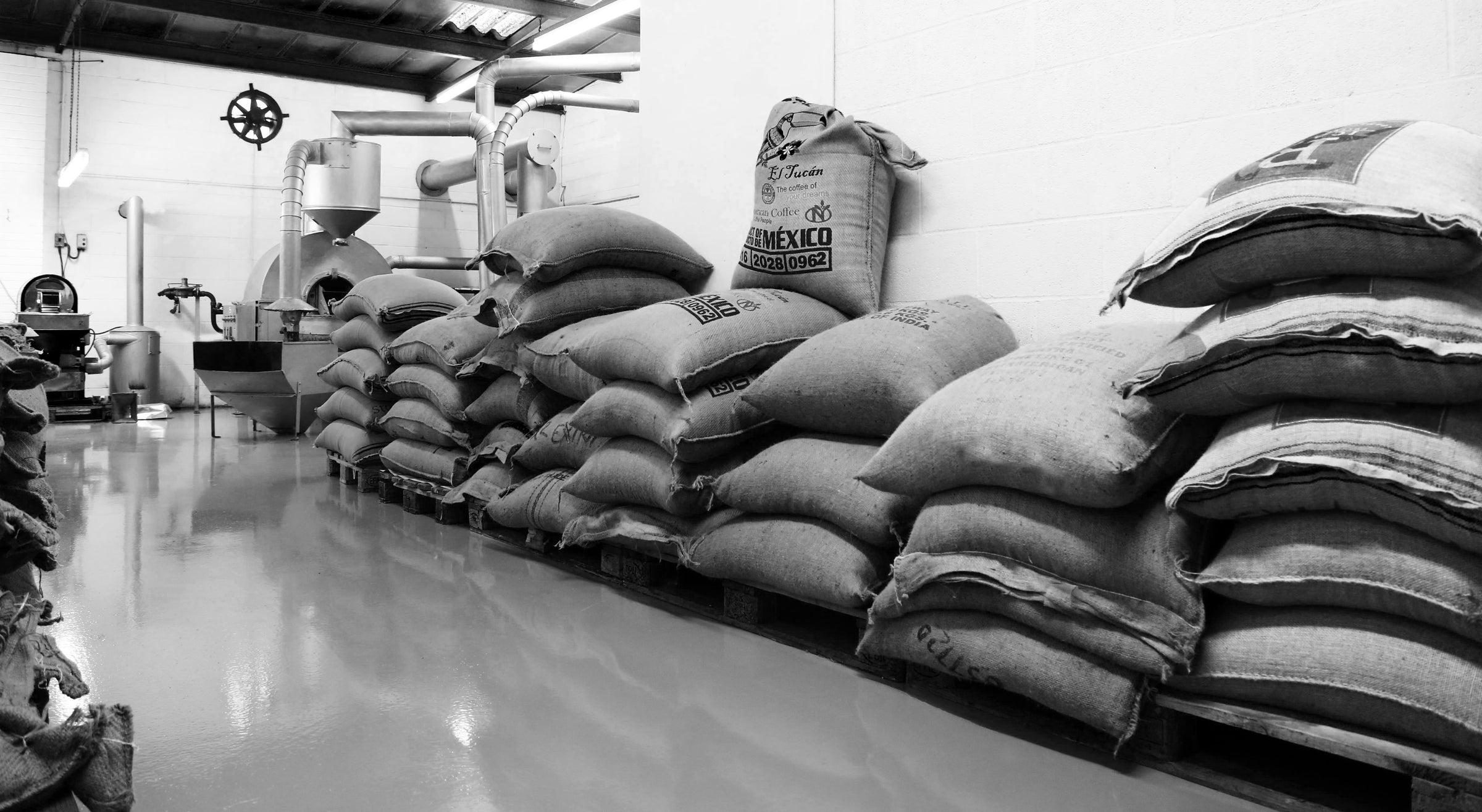 most recent photo of our roastery in kings Lynn Norfolk with our little sample roaster in the background 